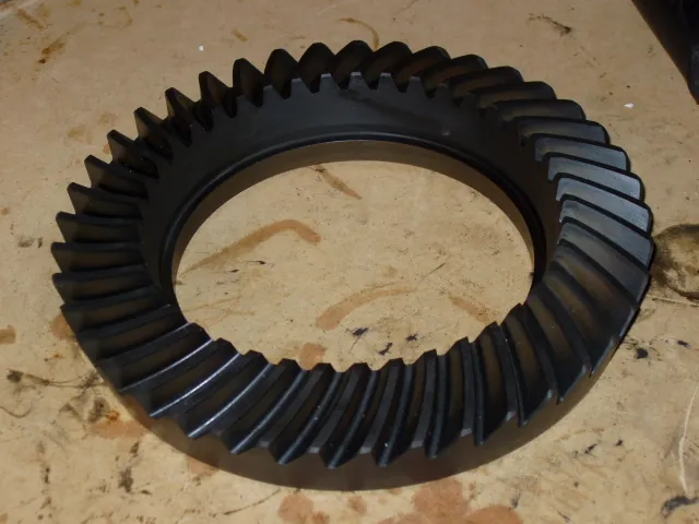 A 4.10 ratio crown wheel for a Chrysler 8.25-inch axle lying on a sheet of cardboard