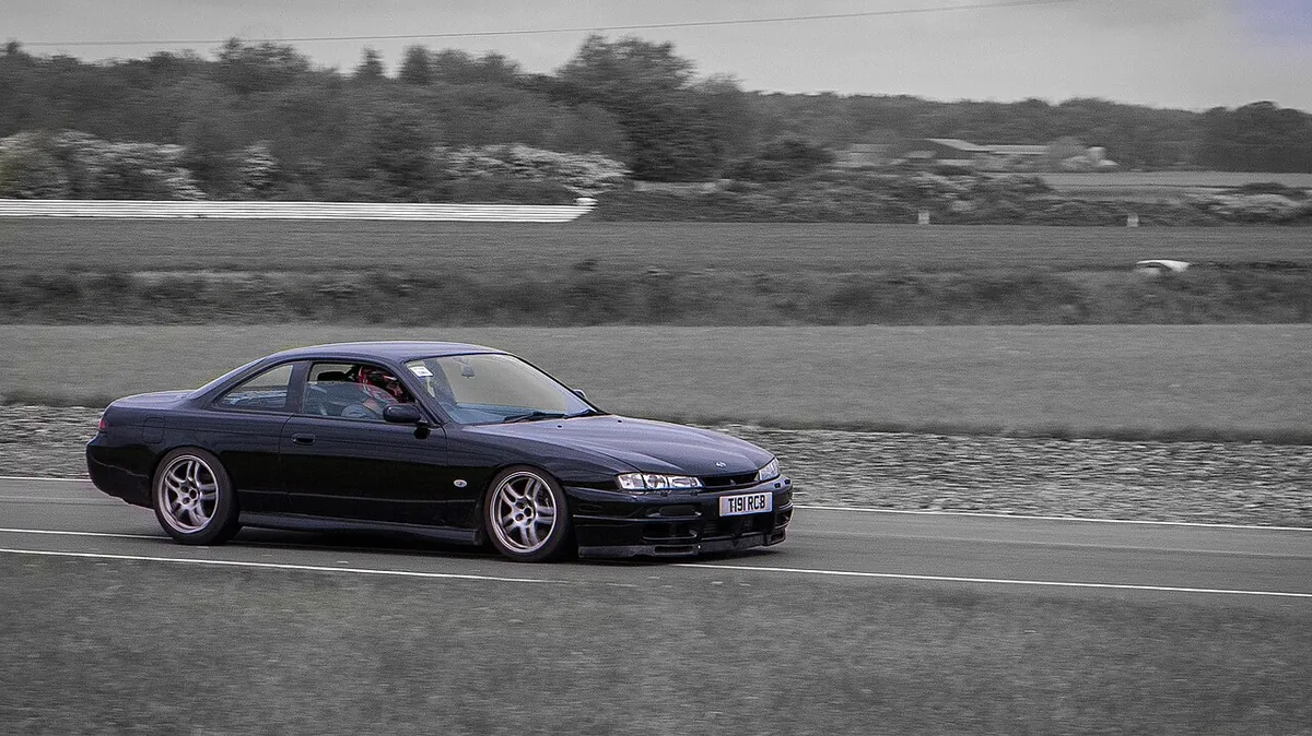A dark Nissan 200SX cornering at a Blyton Park track day in Lincolnshire